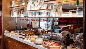A buffet with various food items and a sign that reads "I LOVE YOU MORE THAN HAPPY HOUR, LESS THAN CLOSER". - La Conversation (Paris)