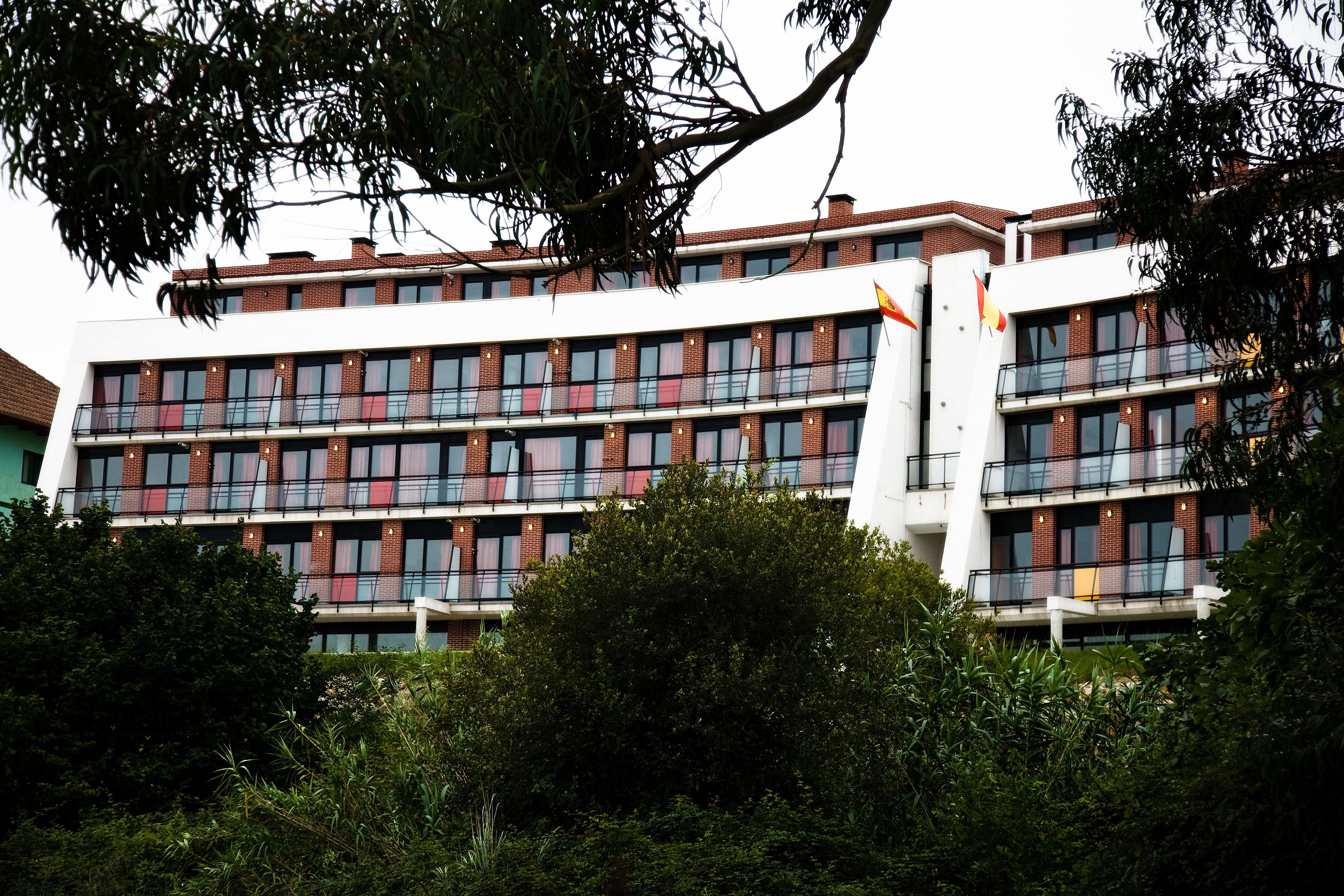 A multi-story building with a modern architectural design, featuring a mix of brick and glass facades.