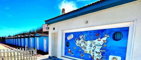 A building with a large map of Italy on the wall, a satellite dish on the roof, and a sign for 'Ristorante La Botte'.