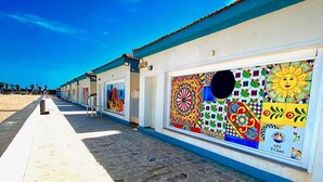 A building with colorful tiled windows and a clear sky. - Villaggio Turistico Internazionale La Plaja (Catania)