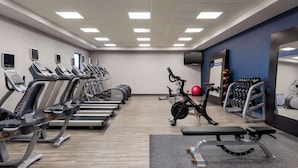 A gym with treadmills, stationary bikes, and weight machines.