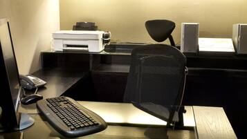 Een bureau met een computer, toetsenbord, muis en printer.