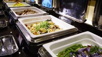 A buffet with various dishes including seafood, salads, and vegetables.