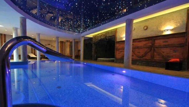 A swimming pool with a starry ceiling and a wooden wall. - Hotel Krysztal Conference & Spa (Szklarska Poreba)