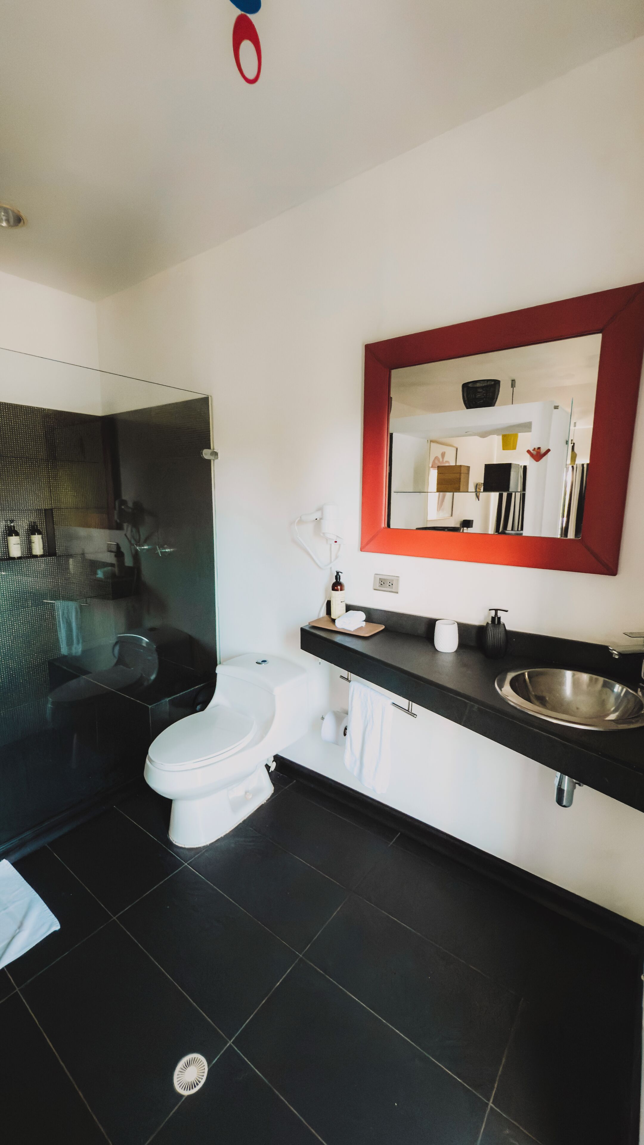 A modern bathroom with a toilet, sink, and shower area.