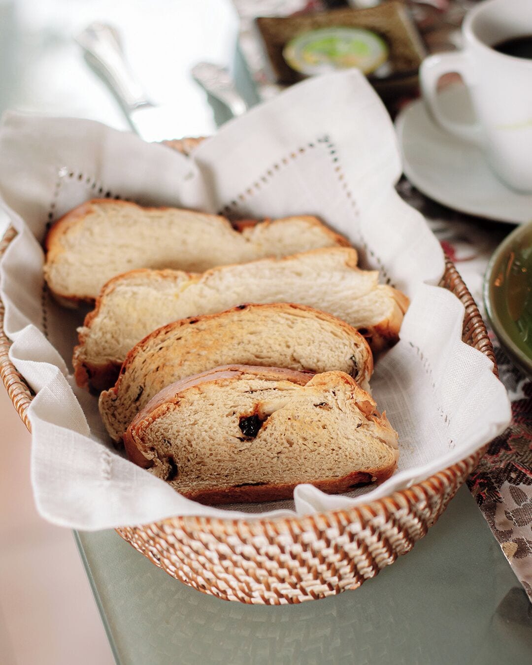 A basket of sliced bread on a table.