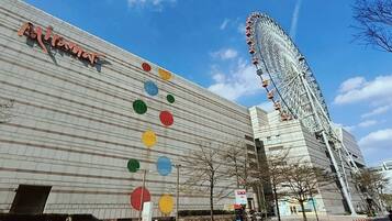 A building with a Ferris wheel in the background and colorful circular decorations on the facade.