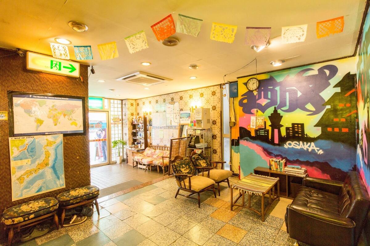 Un hall d’entrée avec une carte du Japon, une horloge et une fresque représentant Osaka.