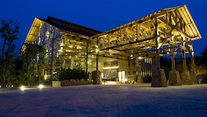 A modern hotel with a glass facade, a spacious entrance, and a paved driveway. - Philea Resort & Spa (Malacca City)