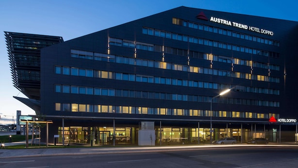 A modern hotel building with multiple floors and large windows. - Austria Trend Hotel Doppio (Vienna)