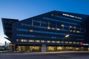 A modern hotel building with multiple floors and large windows. - Austria Trend Hotel Doppio (Vienna)