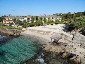A coastal resort with beachfront villas, clear waters, and a thatched-roof gazebo. - Nasama Resort (Port Vila)