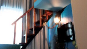 A room with a wooden staircase, a ceiling mural of a whale, and a window with curtains. - YY38 Hotel (Kuala Lumpur)