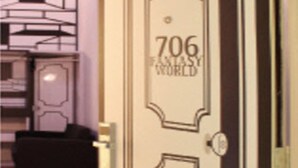 A door with the number 706 and the words "Fantasy World" on it, indicating a themed hotel room. - YY38 Hotel (Kuala Lumpur)