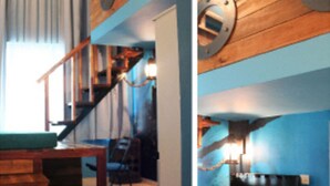 A room with a wooden staircase, a table, and a television. - YY38 Hotel (Kuala Lumpur)