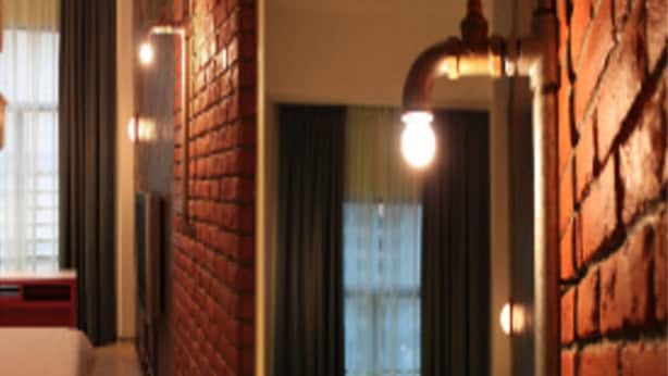 A room with a brick wall, a window with curtains, and a lamp. - YY38 Hotel (Kuala Lumpur)