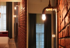 A room with a brick wall, a window with curtains, and a lamp. - YY38 Hotel (Kuala Lumpur)