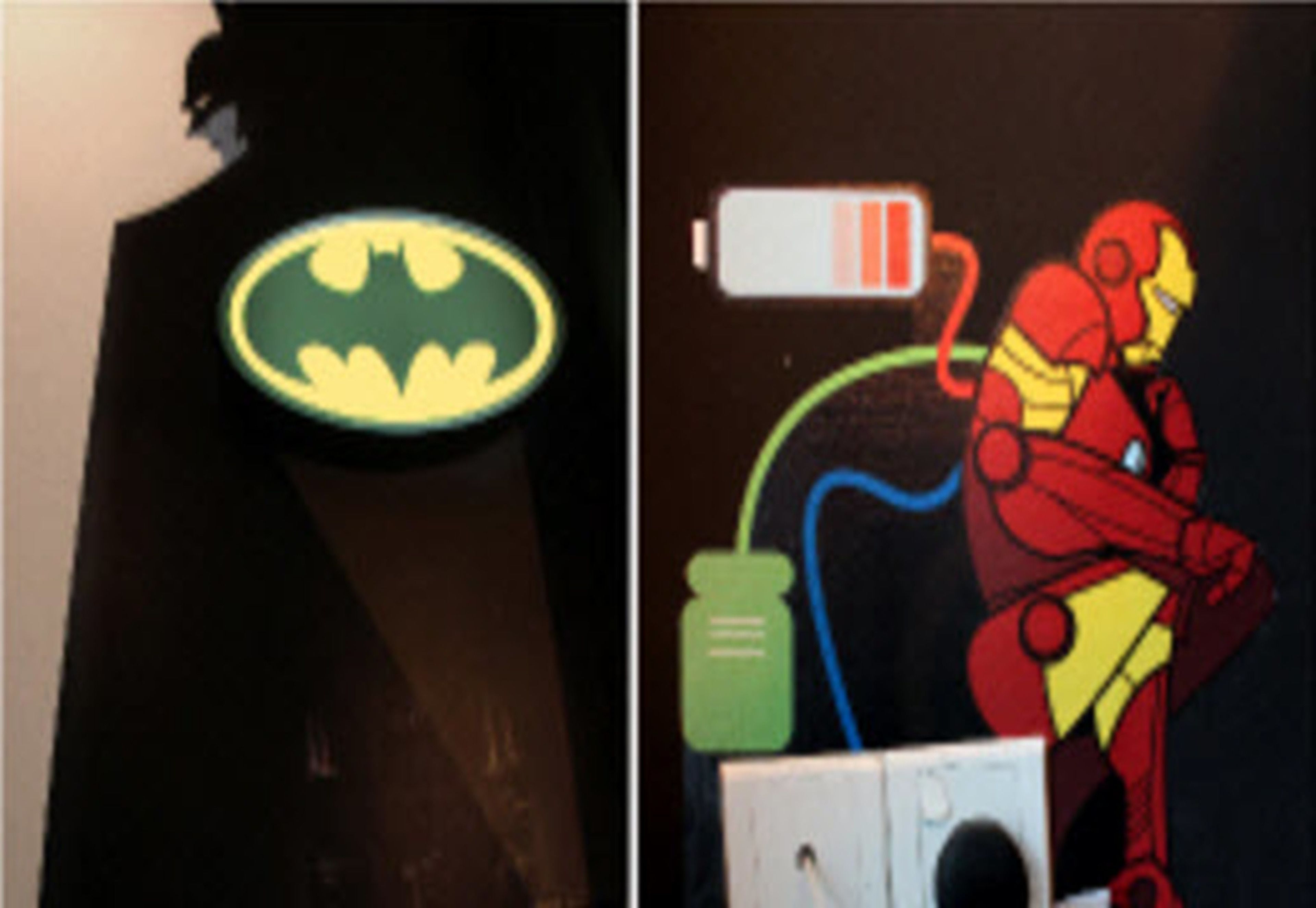 A wall with a Batman logo and a depiction of Iron Man.