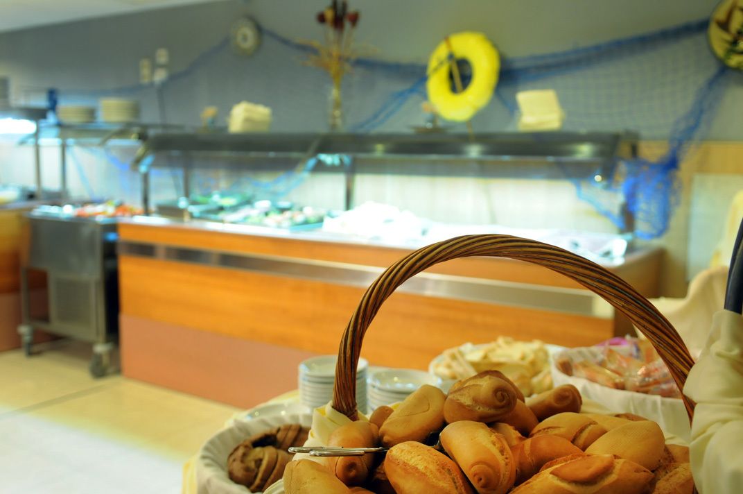 A buffet area with a variety of baked goods and pastries.