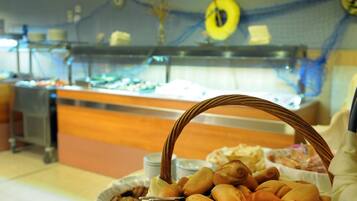 A buffet area with a variety of baked goods and pastries.
