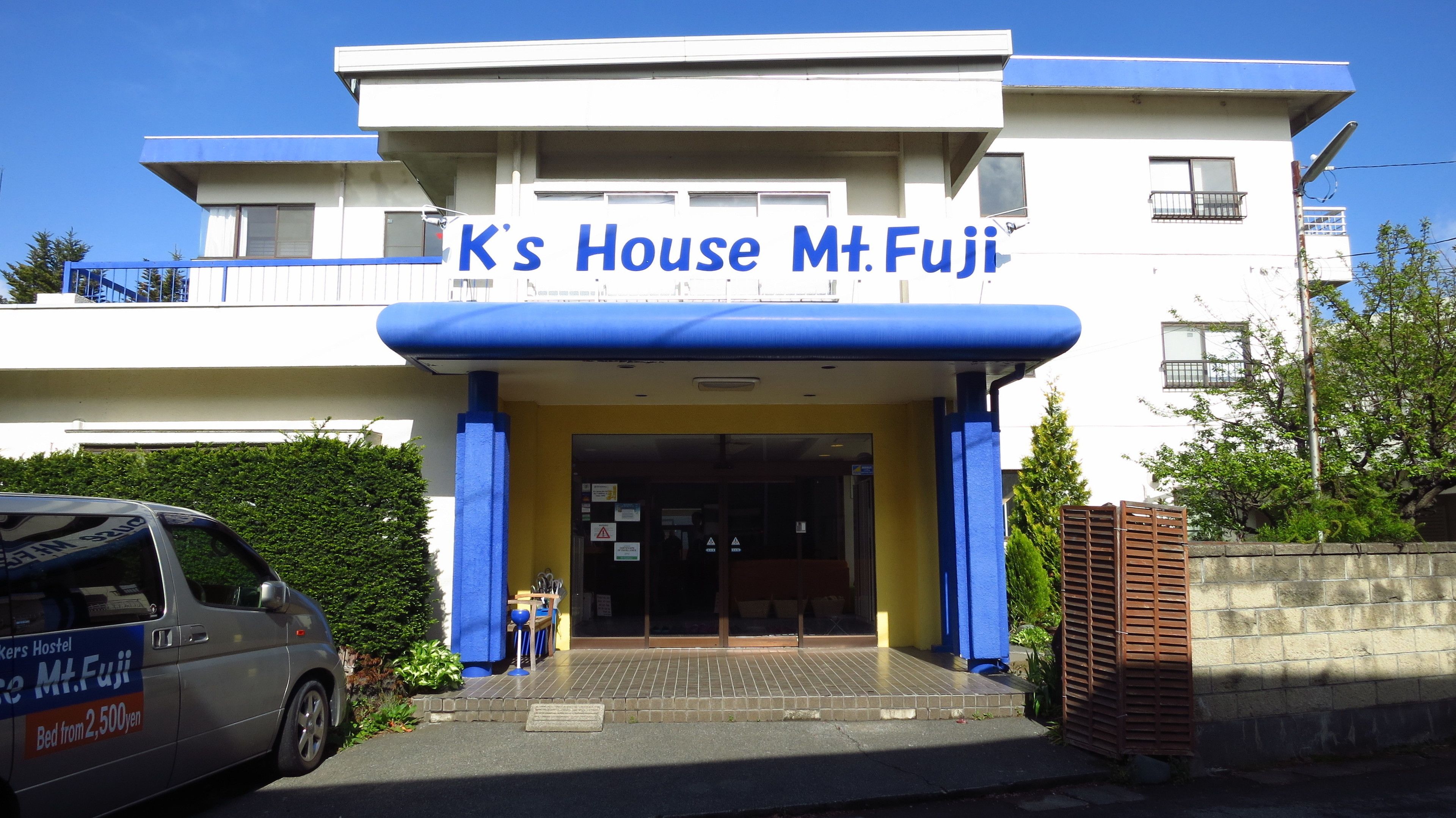 A building with a sign reading "K's House Mt. Fuji".