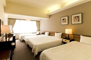 A hotel room with three beds, a desk, and a chair. There are two lamps on the nightstands. - Ryukyu Sun Royal Hotel (Naha)