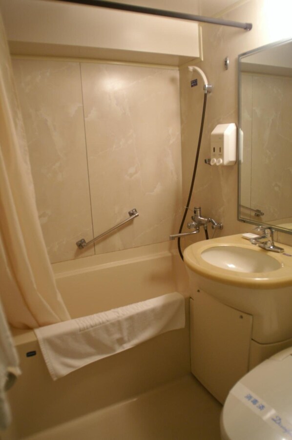 Un baño con bañera, lavamanos y espejo.