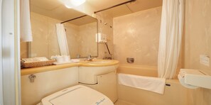 A bathroom with a sink, mirror, shower, and toilet. - Ryukyu Sun Royal Hotel (Naha)