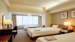 A hotel room with two beds, a desk, a chair, a lamp, and a window with curtains. - Ryukyu Sun Royal Hotel (Naha)