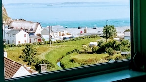 A coastal town with buildings, a beach, and a view of the sea. - Gallen-treath Guest House (Helston)