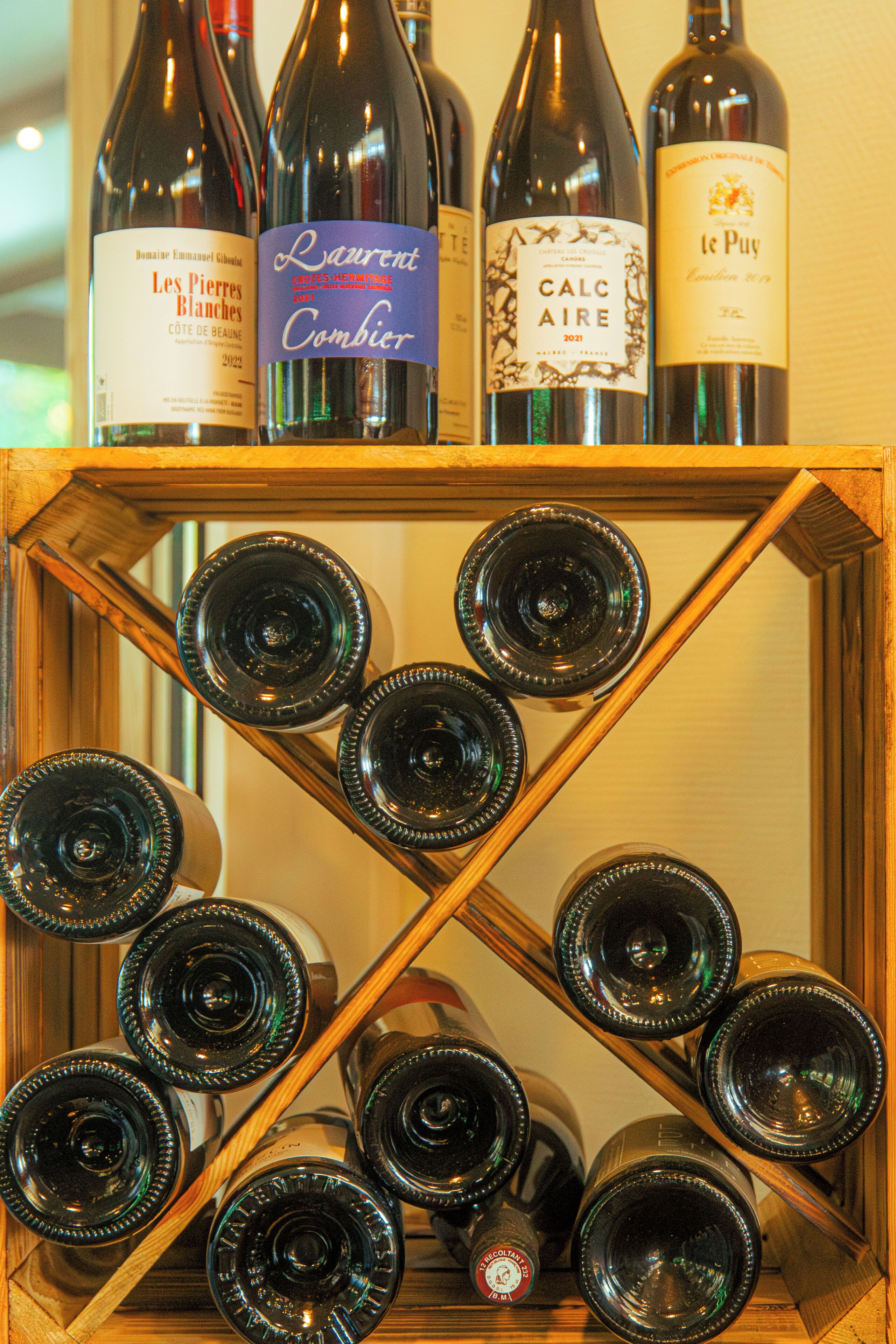 Un porte-bouteilles en bois contenant des bouteilles de vin.