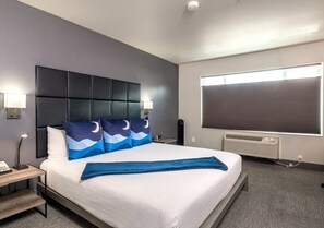 Premium bedding, desk, laptop workspace, blackout curtains