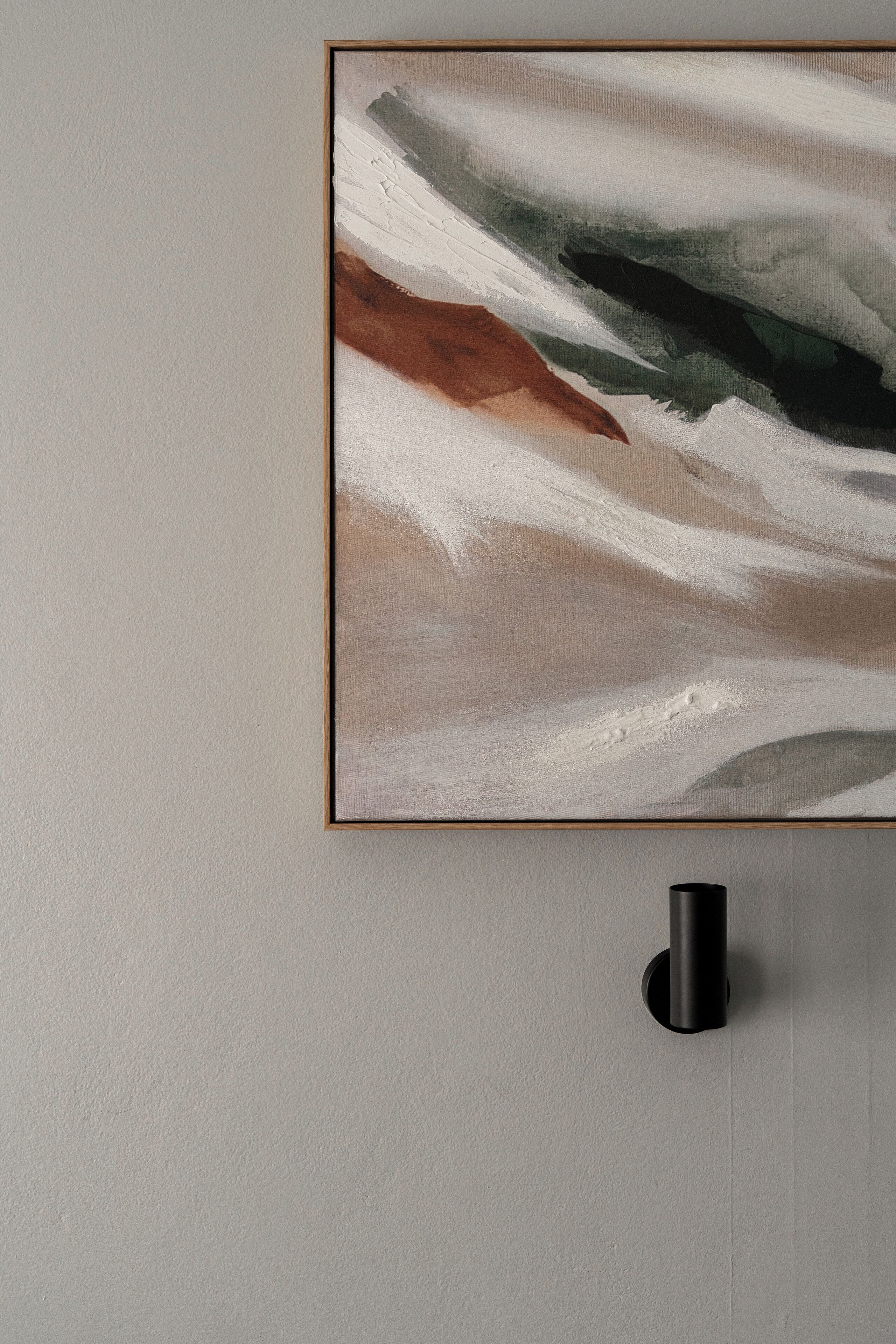 A framed abstract painting on a wall.