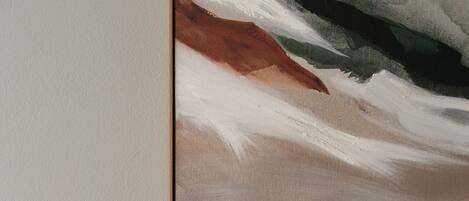 A framed abstract painting on a wall.