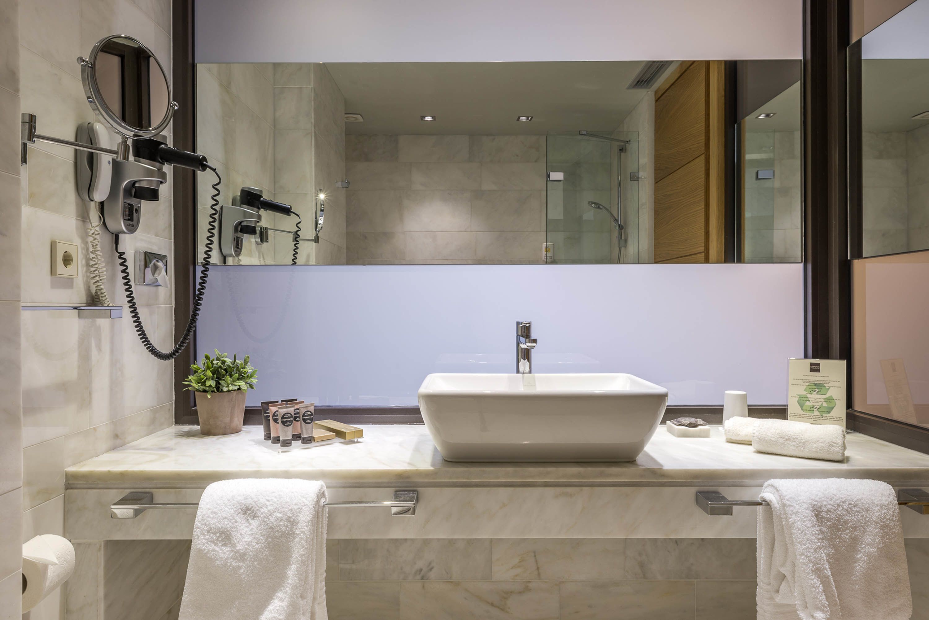 deep-soaking bathtub, designer toiletries, hair dryer, bathrobes