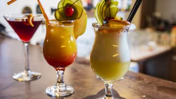 Three cocktails on a bar counter.
