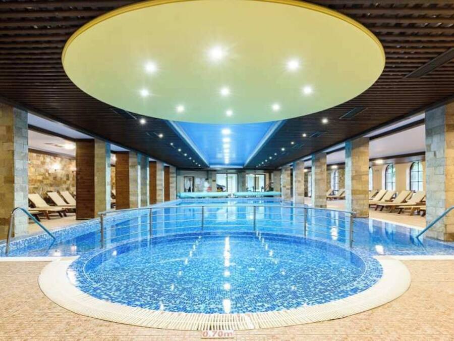 Indoor pool, open 9:00 AM to 8:00 PM, pool loungers, lifeguards on site