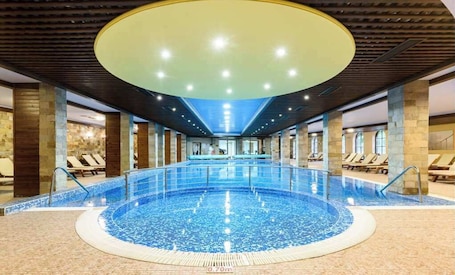 Indoor pool, open 9:00 AM to 8:00 PM, pool loungers, lifeguards on site. Grand Royale Apartment Complex & Spa