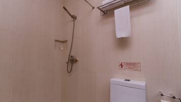 A bathroom with a shower, toilet, and towel rack.