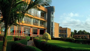 A modern hotel with a glass facade, a central courtyard, and a well-maintained garden. - Protea Hotel by Marriott Entebbe (Entebbe)
