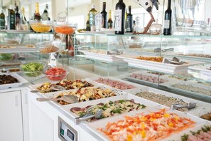 A buffet with various food options and a selection of beverages. - Hotel Silver (Cesenatico)
