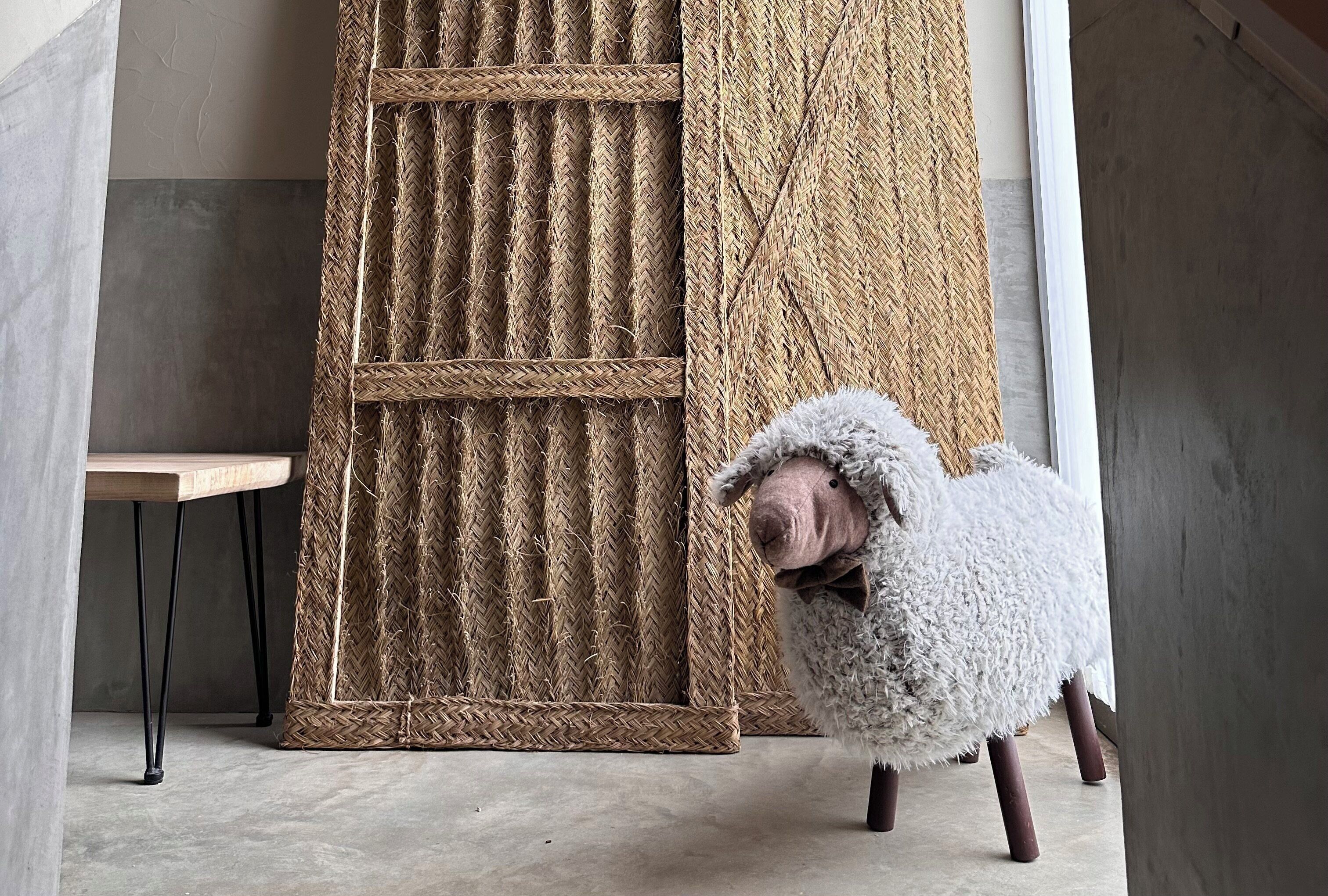 A room with a concrete floor, a woven basket, and a wooden table.