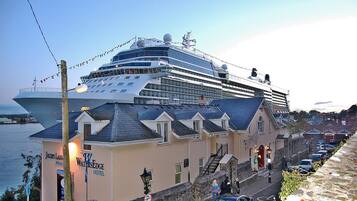 A large cruise ship docked near a hotel named WatersEdge.