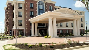 A Holiday Inn Express building with a brick facade, a central entrance with a covered walkway, and a landscaped front yard. - Holiday Inn Express Hotel & Suites Marion Northeast by IHG (Marion)