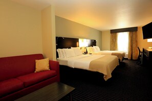 A hotel room with two beds, a red sofa, a desk, and a TV. - Holiday Inn Express Hotel & Suites Marion Northeast by IHG (Marion)