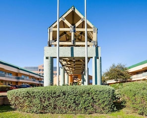 A multi-story building with a central atrium and a flat roof.