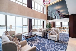 A spacious lobby with high ceilings, large windows, and a modern chandelier. - Crowne Plaza Zhenjiang by IHG (Zhenjiang)