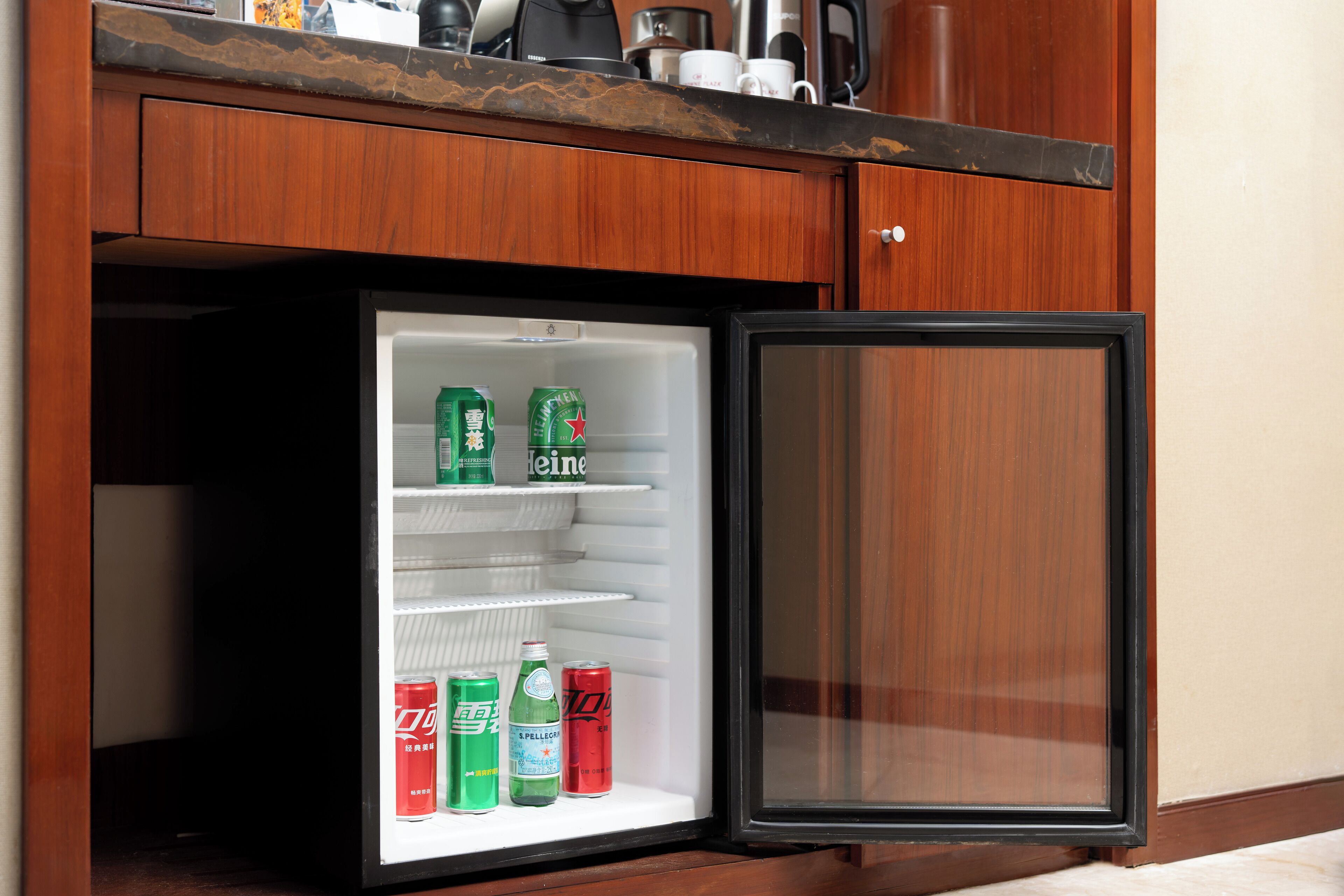 A small refrigerator with shelves containing various beverages.