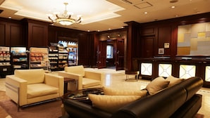 A lobby with a chandelier, a reception desk, and seating areas. - GRG Hotel Naha Higashimachi (Naha)