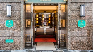 The entrance to GRG Hotel Naha with a red carpet and a glass door. - GRG Hotel Naha Higashimachi (Naha)